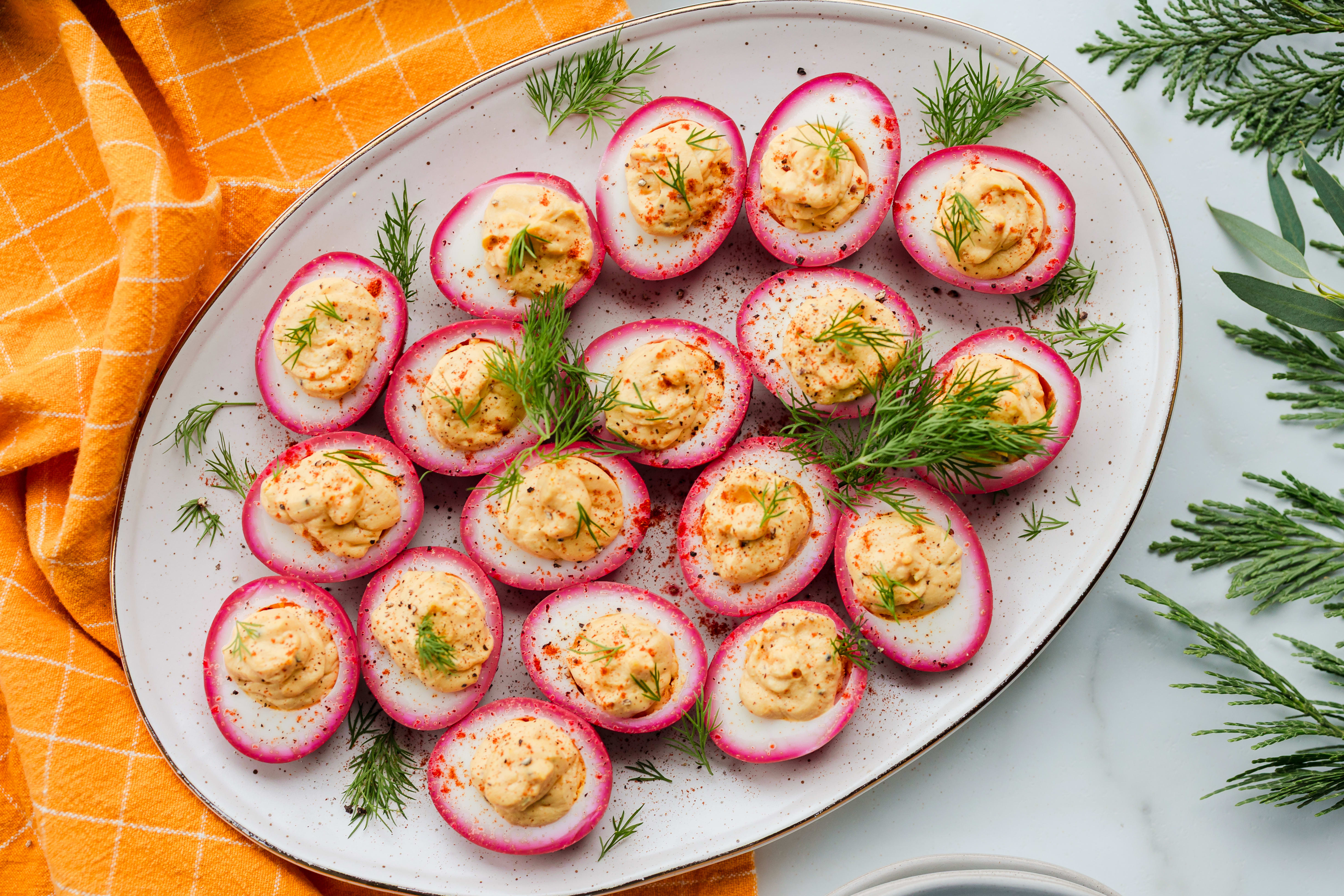 Pickled deviled eggs on a platter.