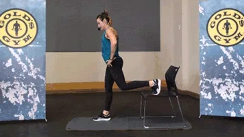 Woman does Bulgarian split squat during chair workout