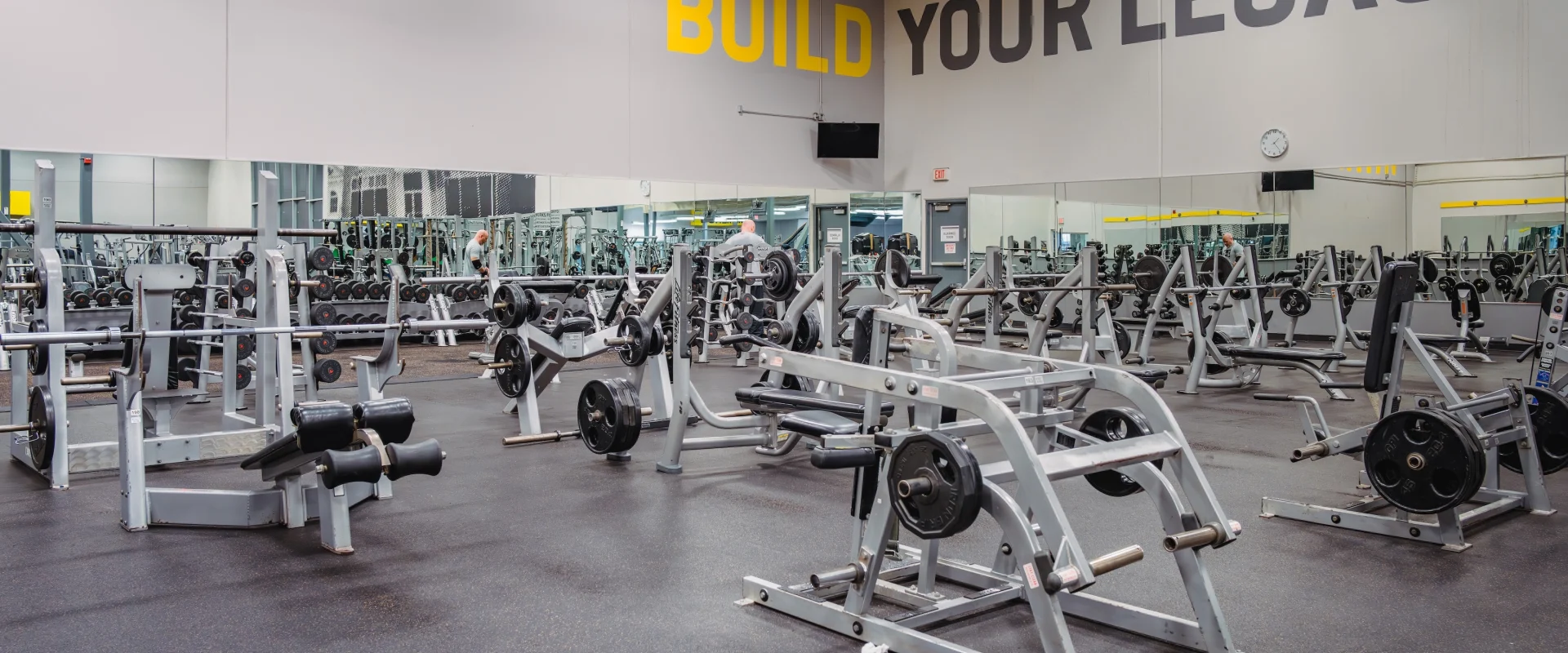 Free weight area arranged with over 10 pieces of plate-loaded weight equipment.