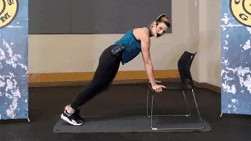 Woman does mountain climbers during chair workout