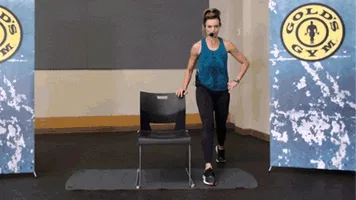 Woman does lunge exercise with chair