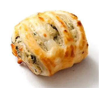 A golden-brown, flaky pastry filled with what appears to be a savory mixture, resting on a plain background.
