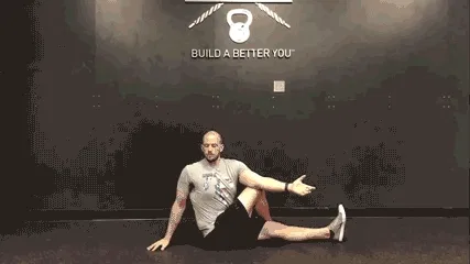 Man doing daily movement routine in the gym with an easy seated twist exercise