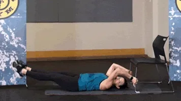 Woman does leg drops as part of chair workout