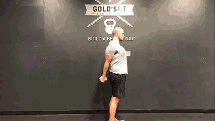 Man doing daily movement routine in the gym with a chest opener exercise