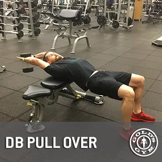 A person is performing a DB pull-over exercise on a weight bench in a gym setting, surrounded by various exercise equipment.