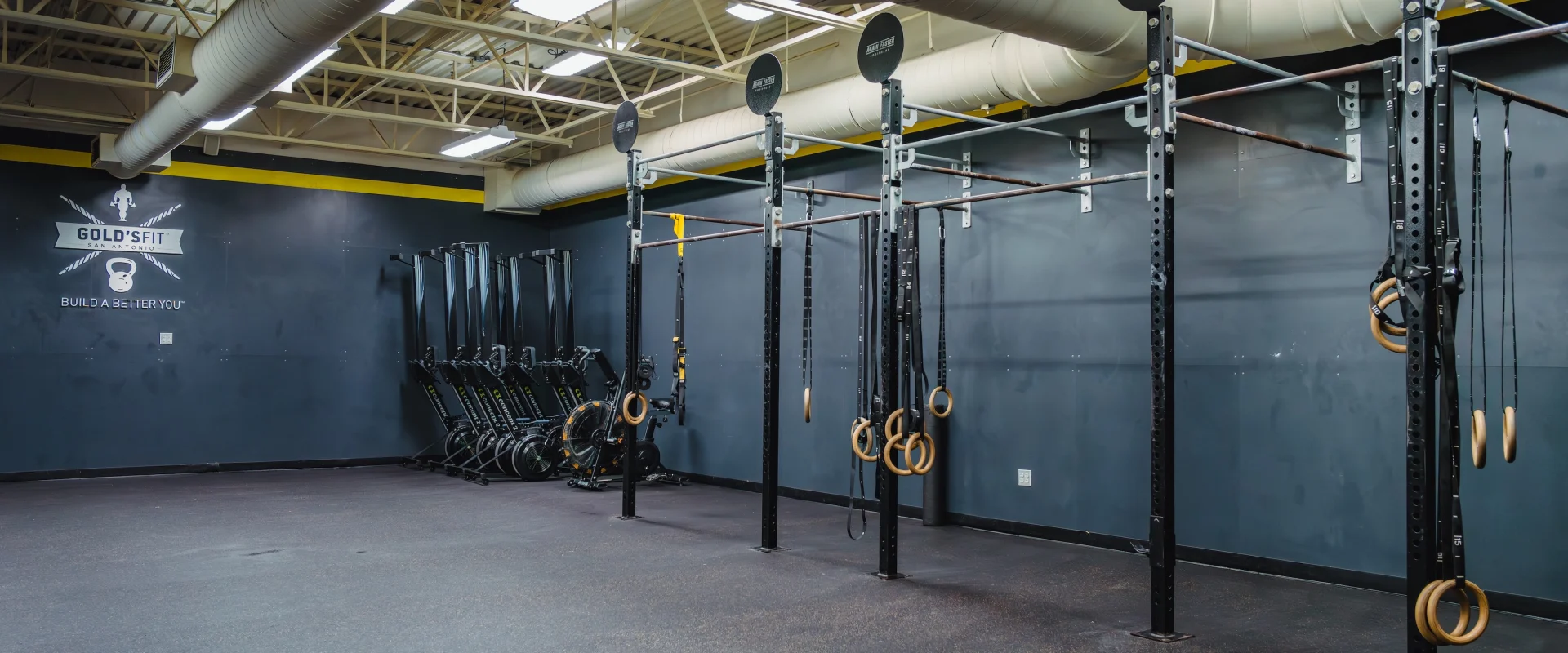 A large room prepared for a class setting with mounted ring bars.