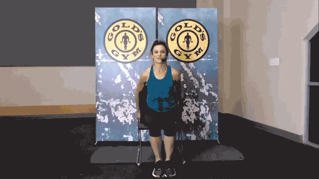Woman does chest stretch during chair workout