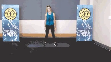 Woman doing right shoulder stretch in the gym.