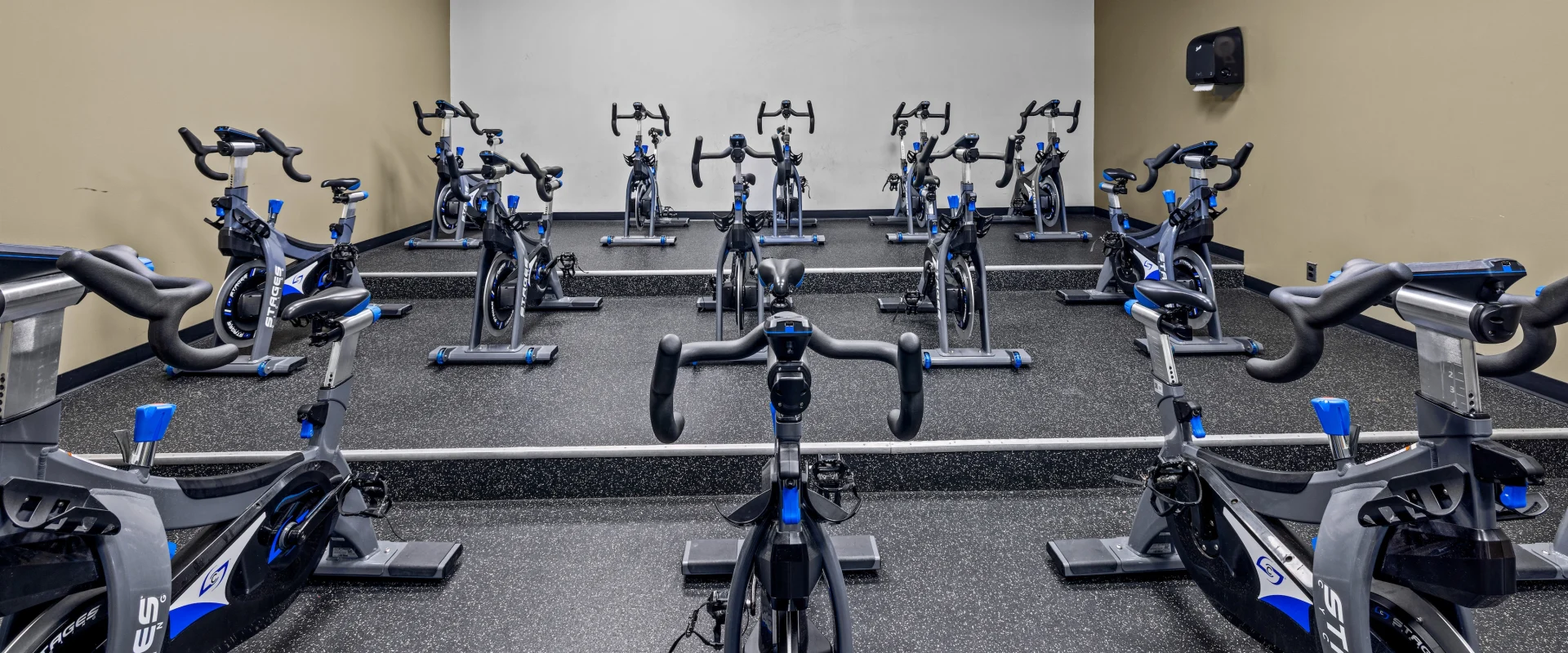 A room showing off a collection of exercise bikes.