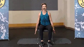 Woman does lateral bend during chair workout