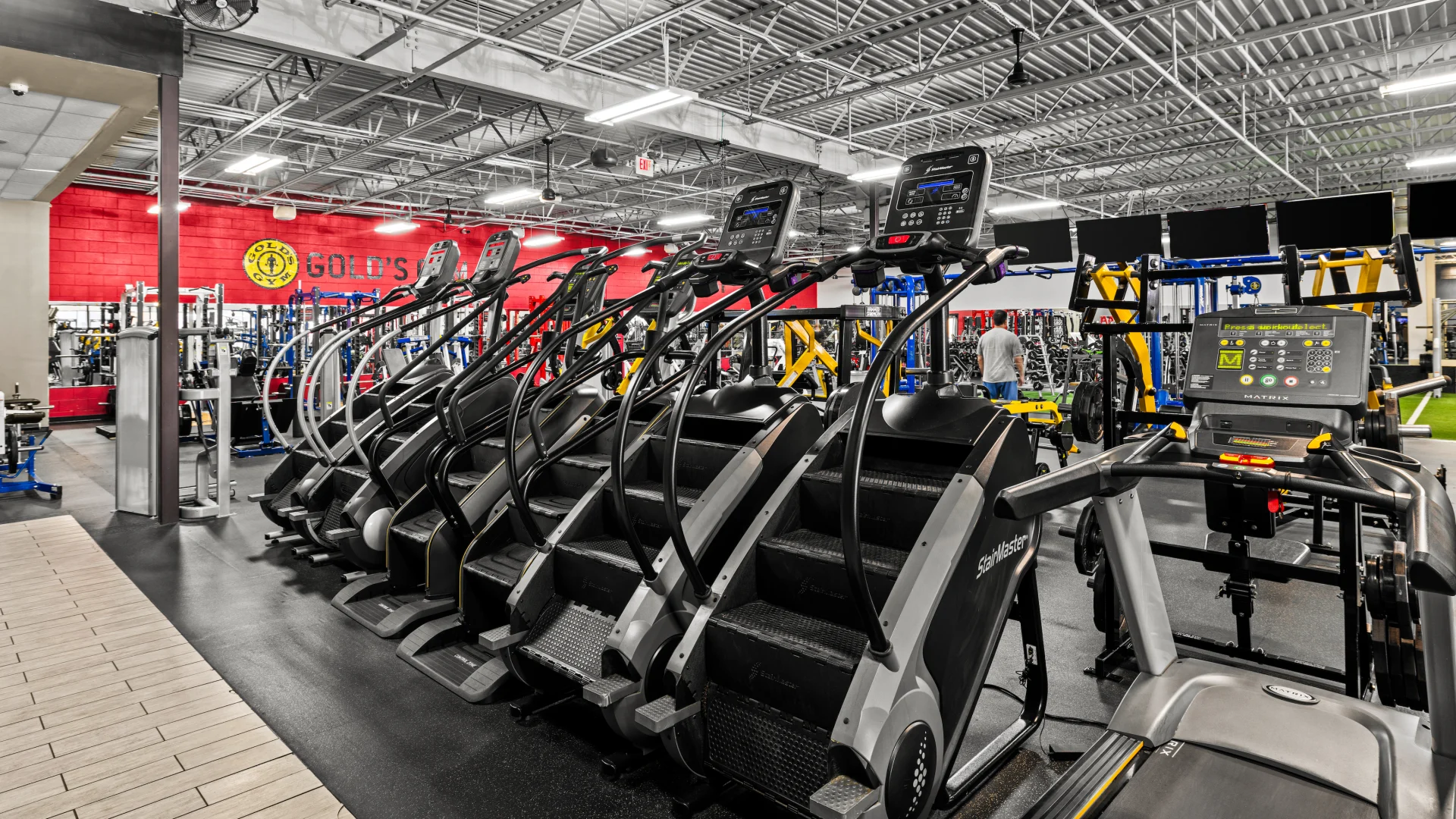 Row of stair climbers in Gold’s Gym cardio area.