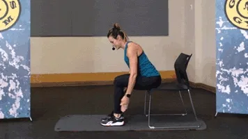 Woman does IYT exercise during chair workout in gym