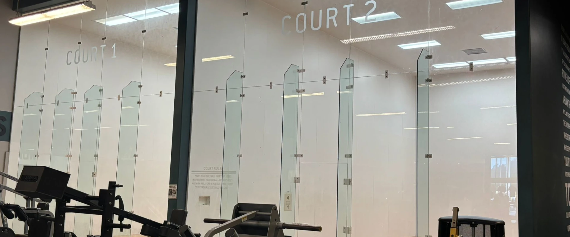 Indoor racquetball courts with glass walls inside Gold’s Gym South Texas in Harlingen.