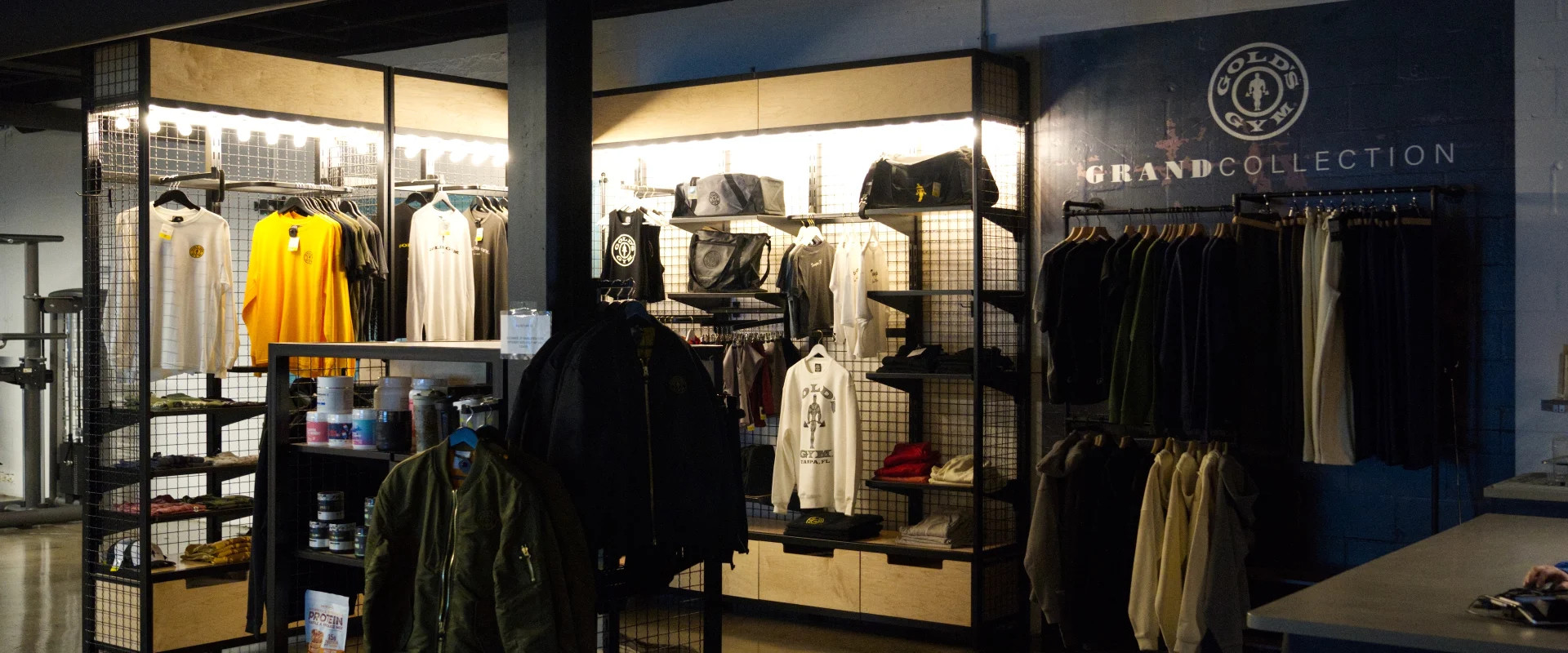 Gold’s Gym (Gas Worx) Pro Shop featuring apparel, jackets, and supplements on display.