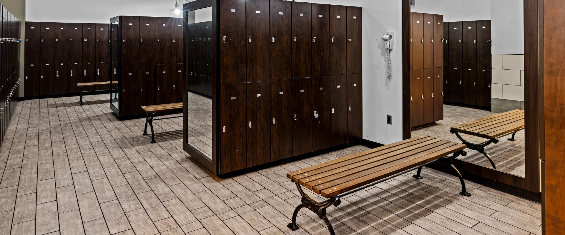 Lockers, mirrors, seating benches with three cutouts for changing.