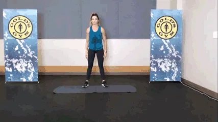 Woman doing shoulder rolls in the gym.