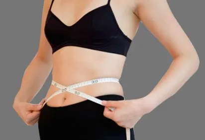 The image shows a person wearing a black bra and measuring their waist with a tape measure.