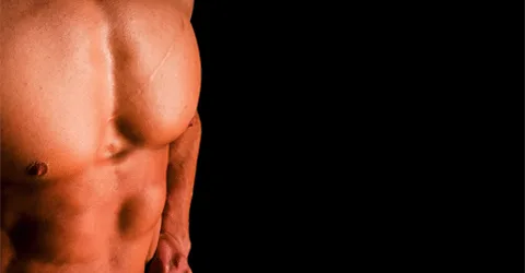 A muscular, shirtless torso is visible against a dark background, highlighting the defined musculature and contours of the body.