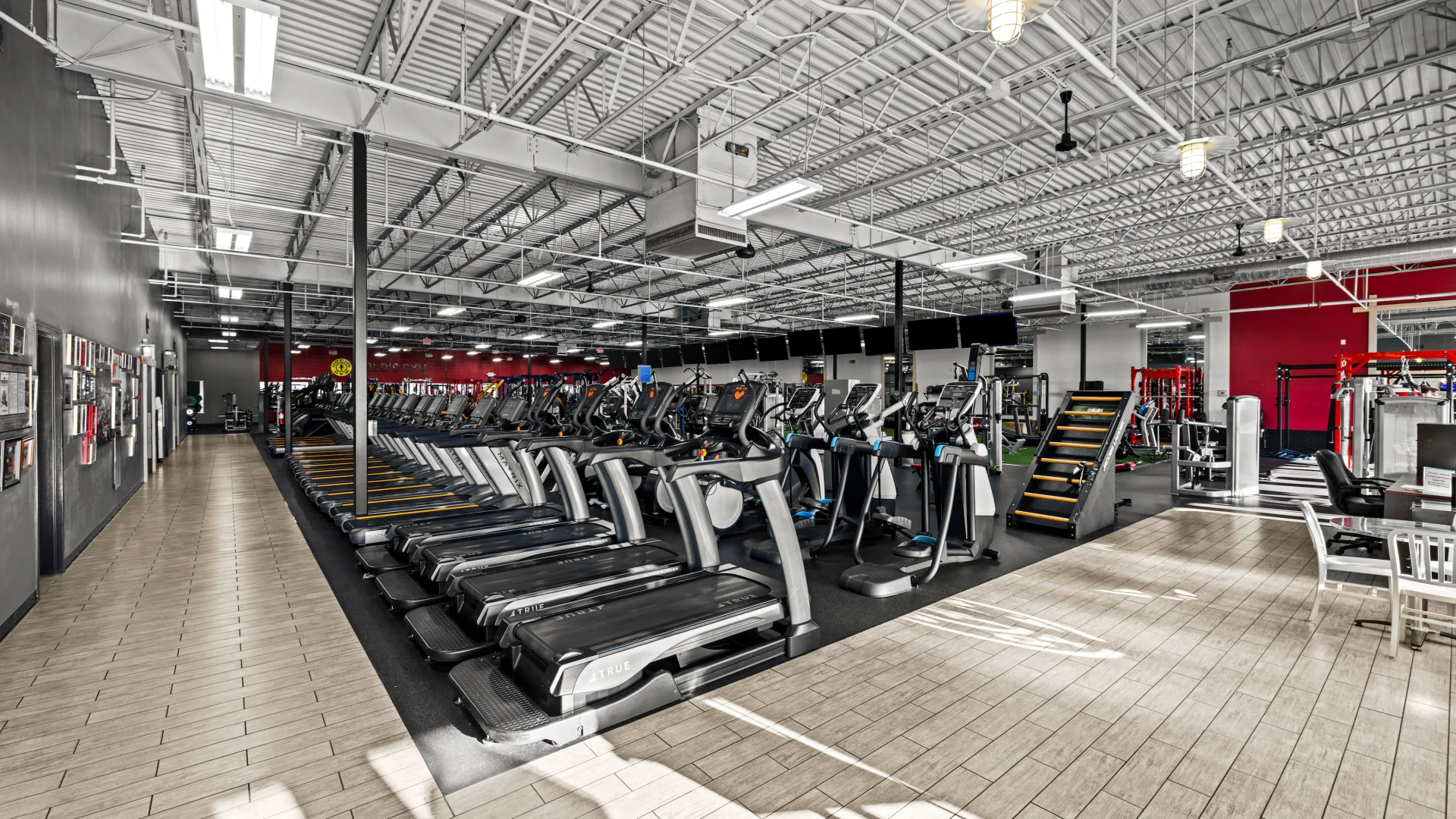 Treadmills and cardio machines inside Gold’s Gym.