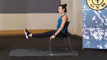 Woman does adductor/abductor exercise during chair workout