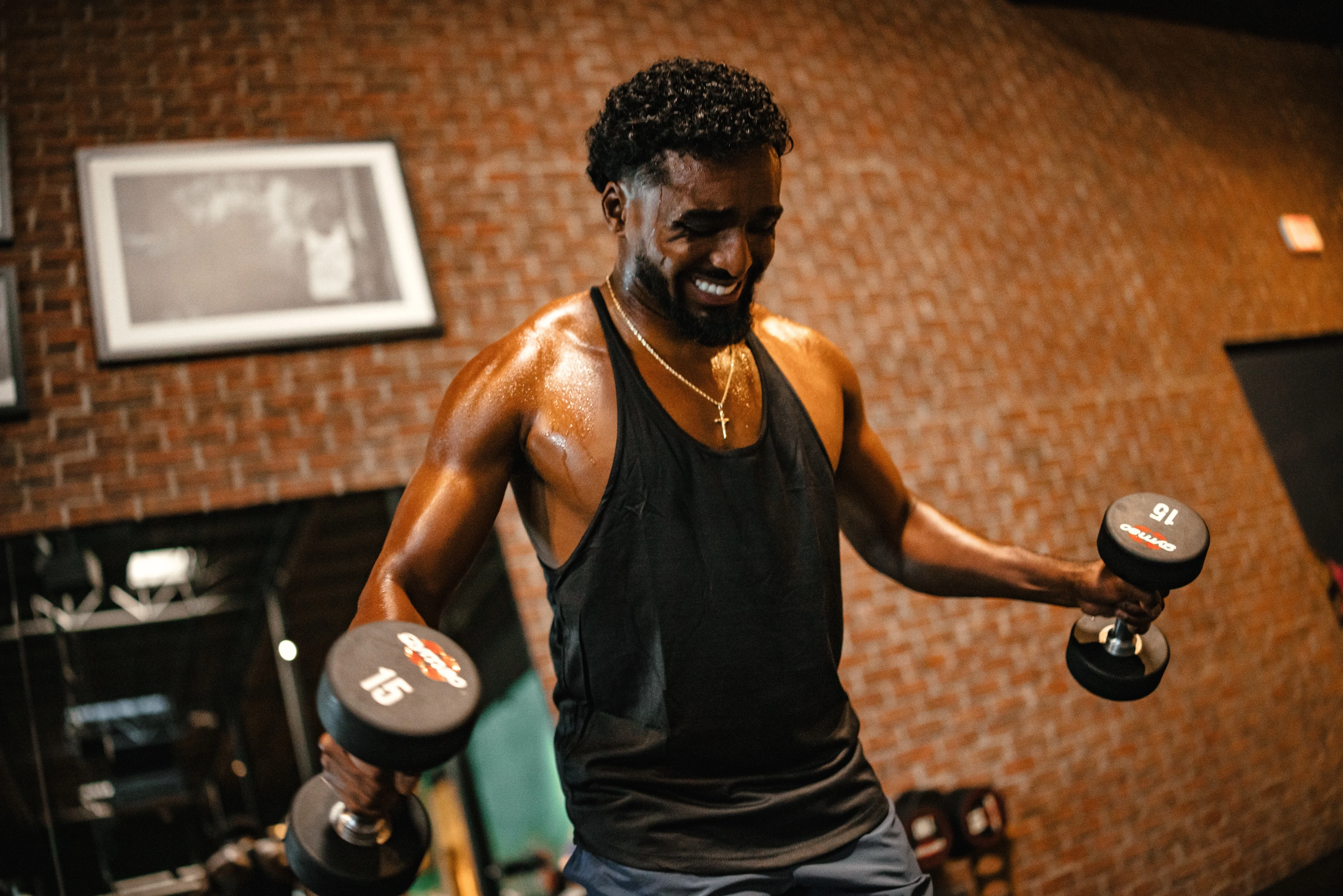 Man holding dumbbells, doing a shoulder workout