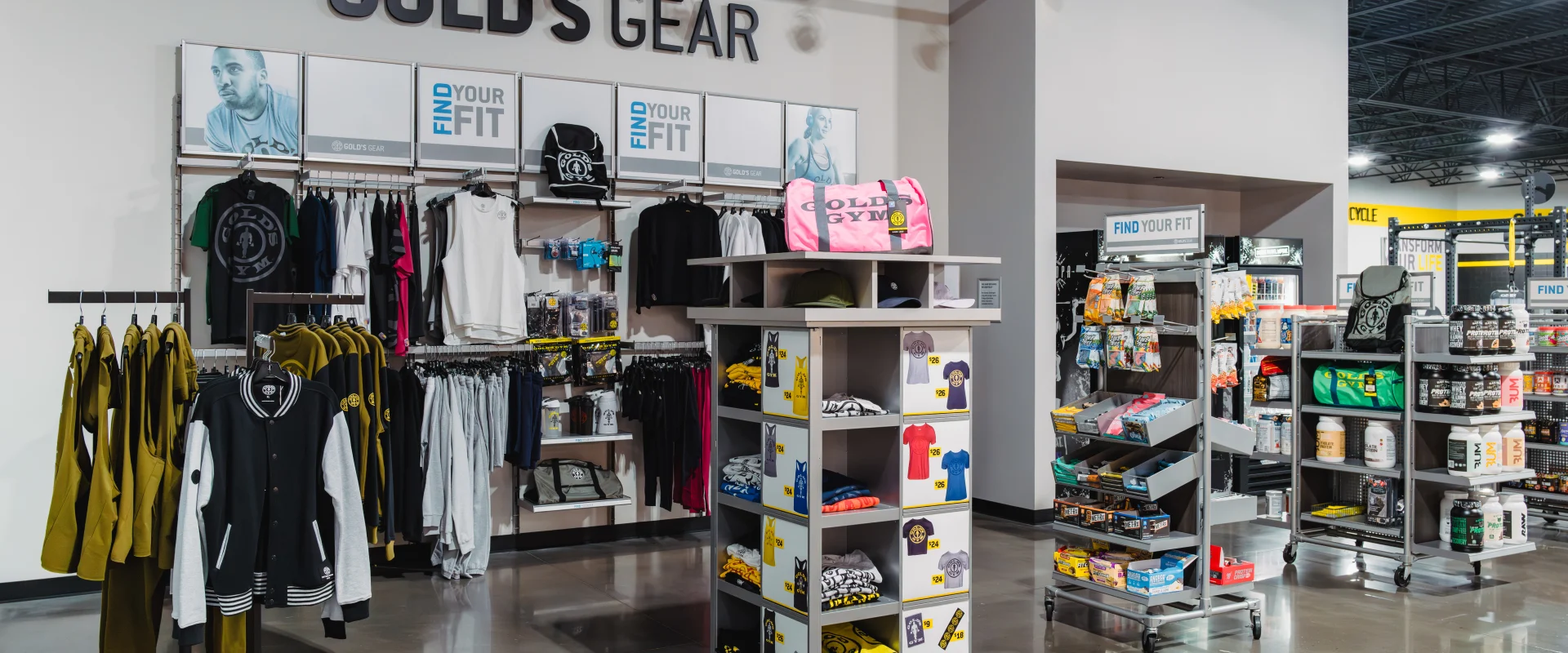 Pro Shop at Gold’s Gym Belterra, featuring racks of branded apparel, accessories, and gym bags, along with shelves stocked with supplements and fitness products.