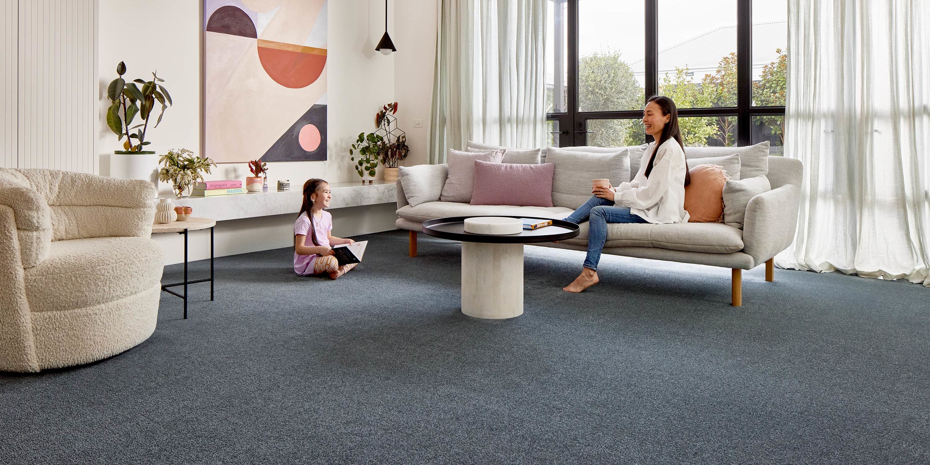 Family in living room on top of Coonawarra carpet from Redbook