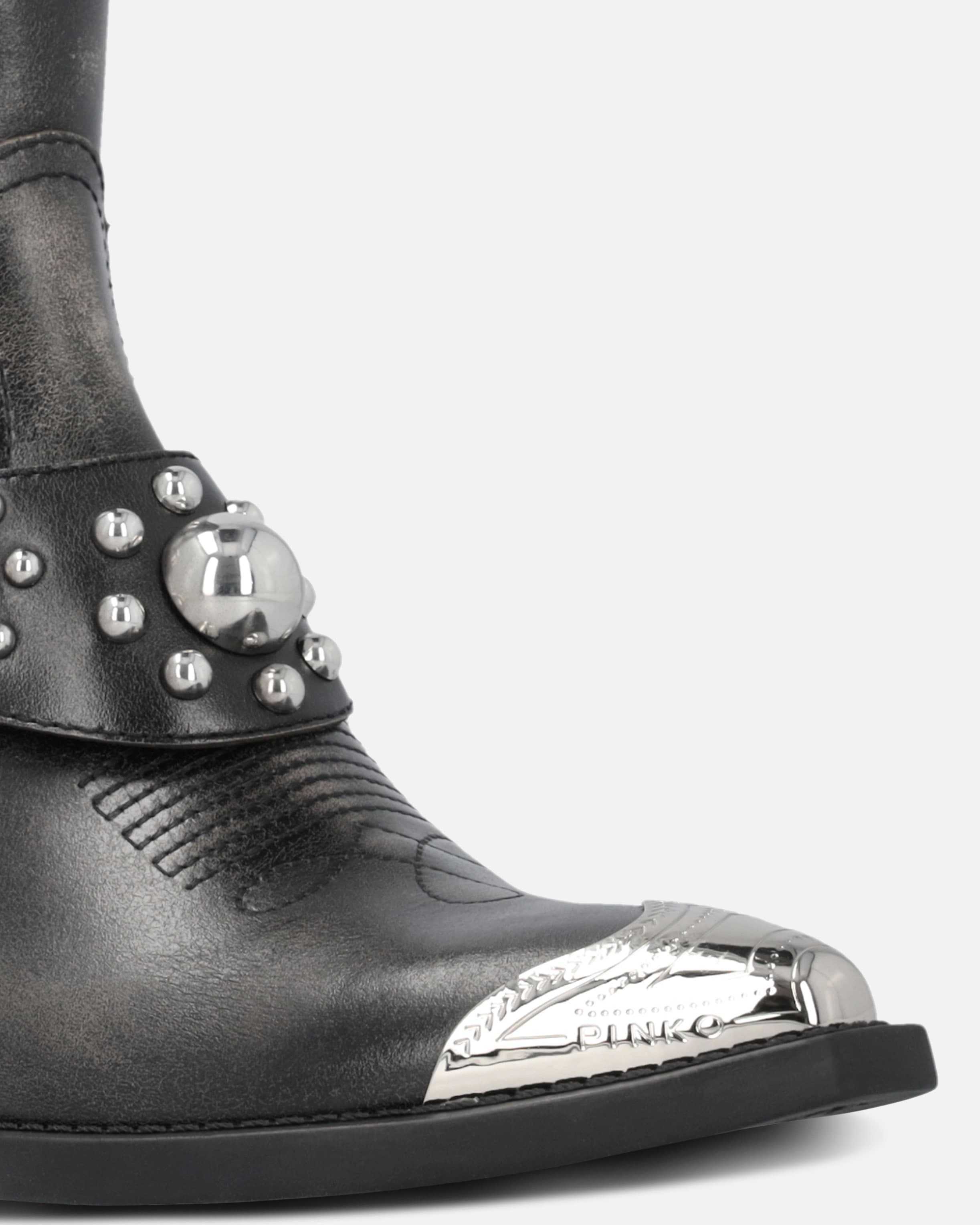 Ankle cowboy boots in distressed leather with a metal toe cap
