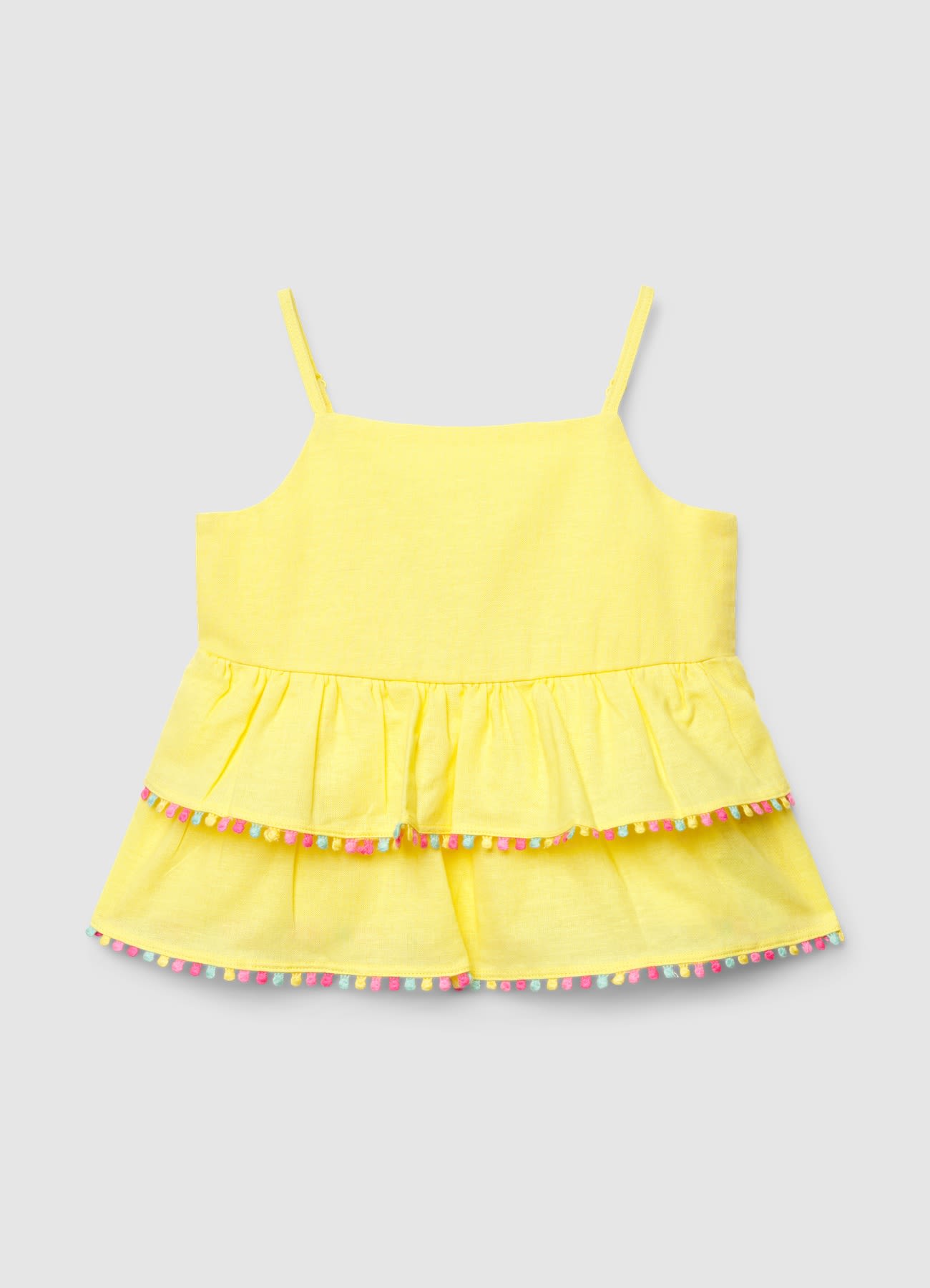 Top con balze e profilo con pompon