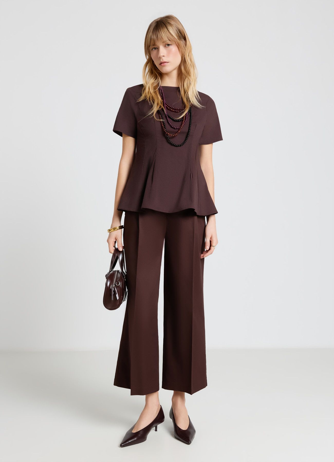 Blusa peplo con zip sul retro