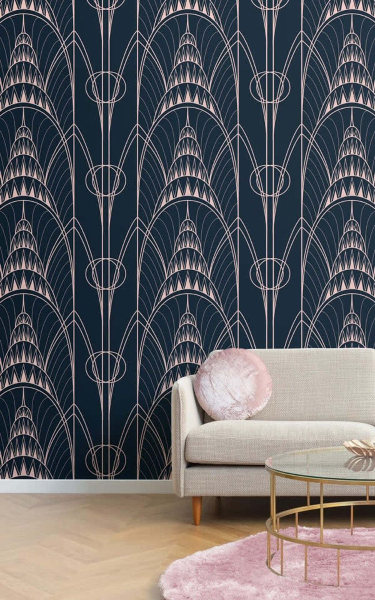 A modern living room featuring an elegant beige sofa against a dark blue wallpaper adorned with a detailed Art Deco-style geometric pattern in light pink lines.