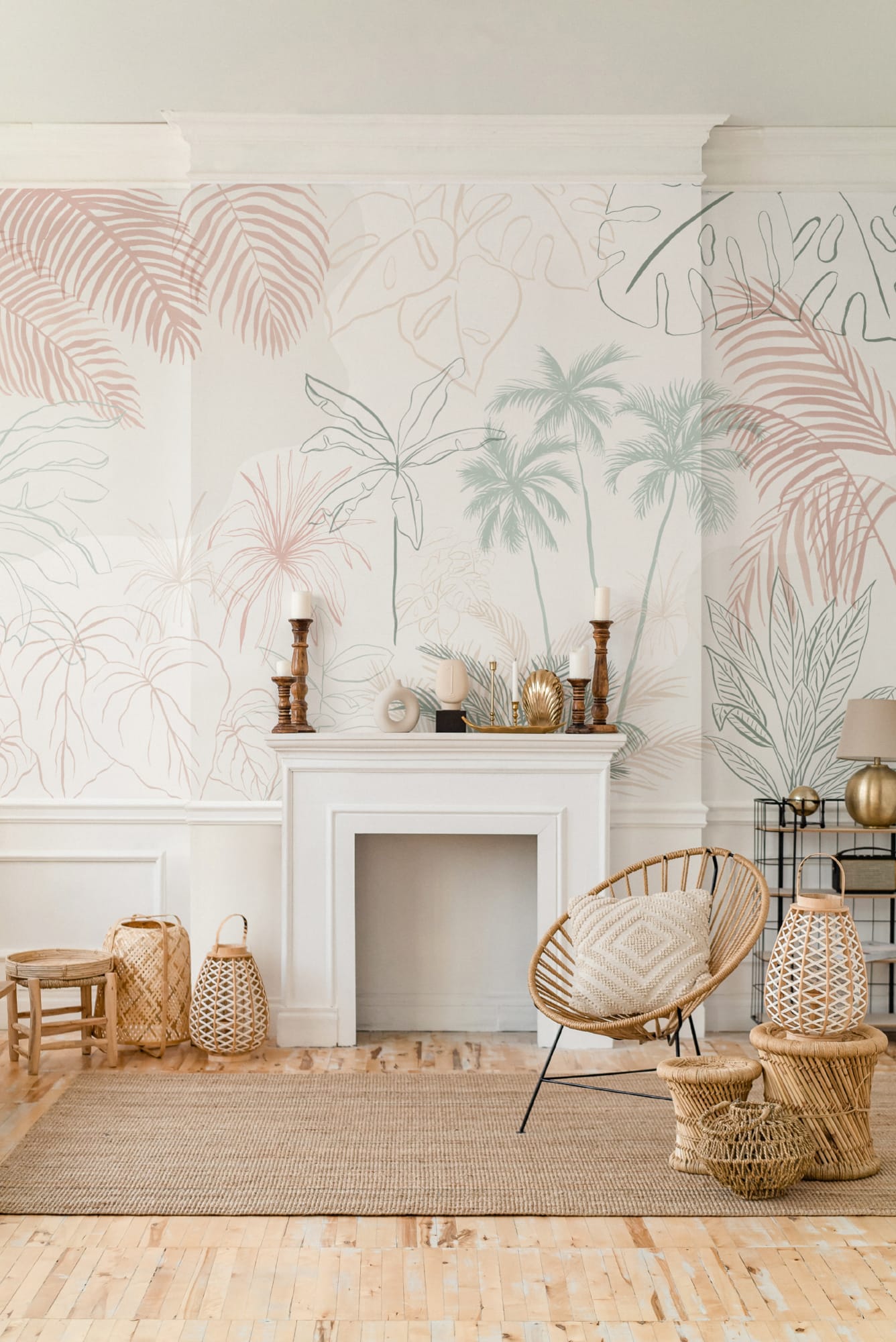 A soft tropical palm mural in muted tones wraps around the fireplace wall, styled with rattan furniture and woven accessories.
