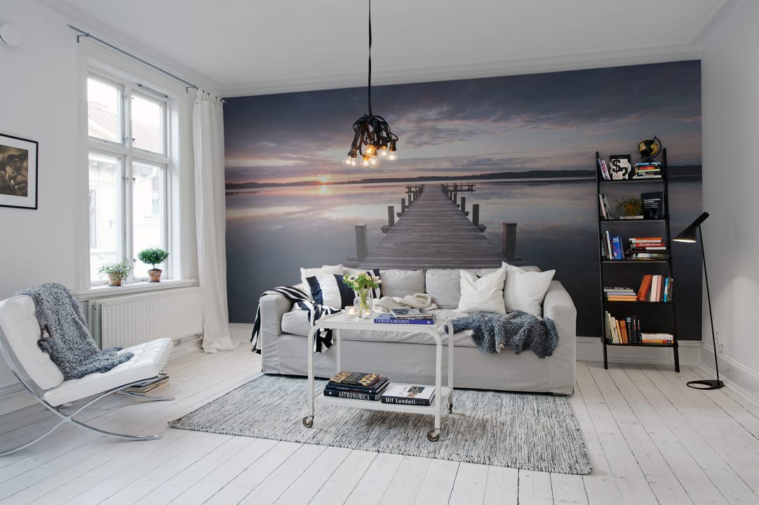 Muurschildering met een zonsondergang in de zee