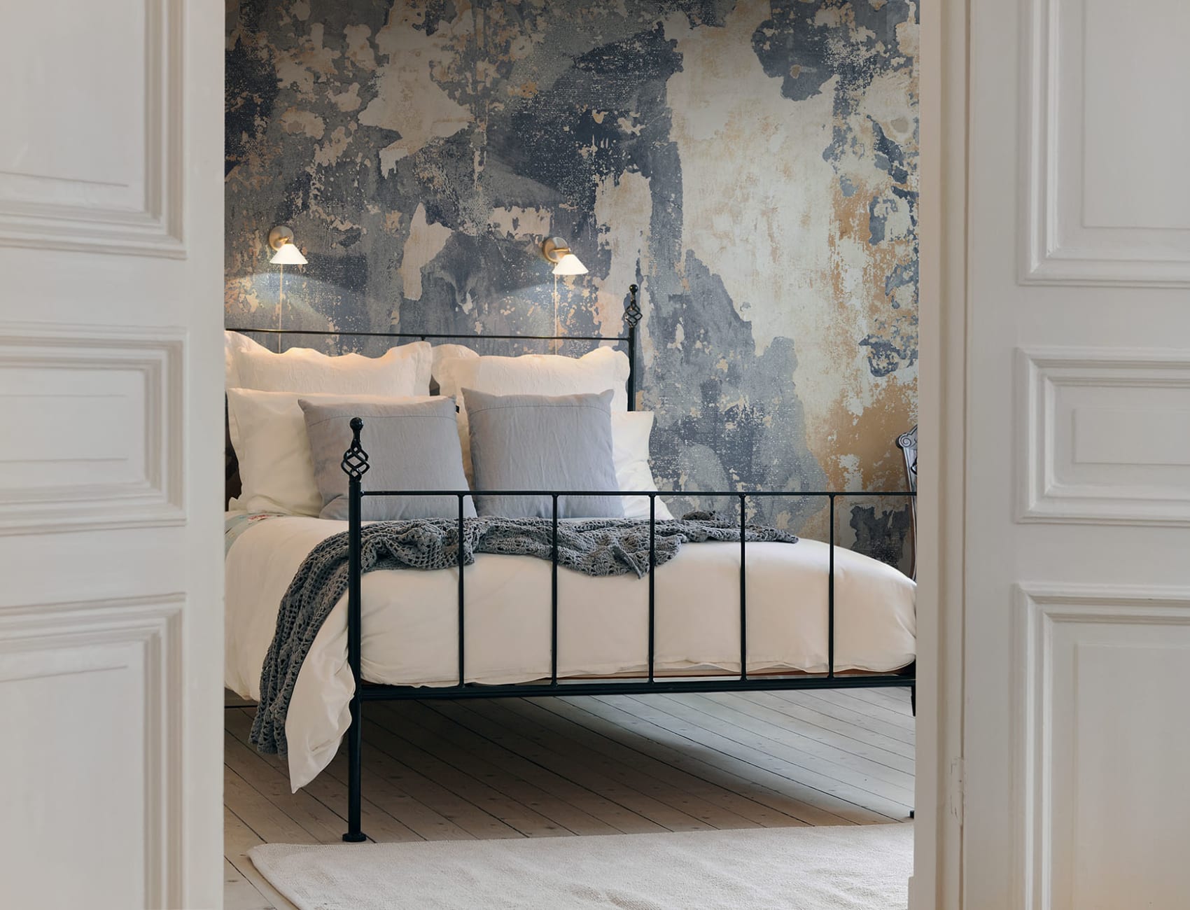 Surface wallpaper layers in a worn wall mural