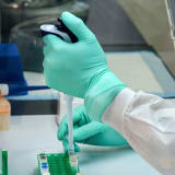 Photo of a Scientists hand doing experiments in a science lab by CDC on Unsplash