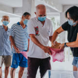 Photo pf people lining up waiting for food donations by Melanie Lim on Unsplash