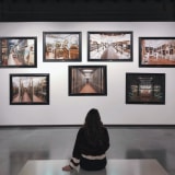 Photo of a woman sitting in front of artworks by Klaudia Piaskowska on Unsplash