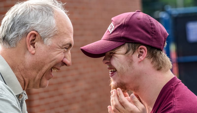 Photo of 2 men smiling at each other by Nathan Anderson on Unsplash