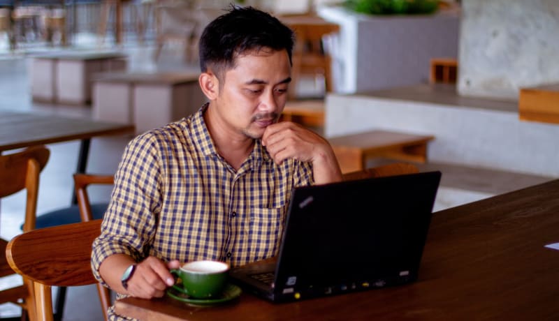 Photo of a man looking at a laptop by Nasik Lababan on Unsplash