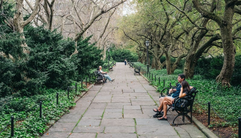 Photo of people sitting on a bench in a park by Tomas Anton Escobar on Unsplash