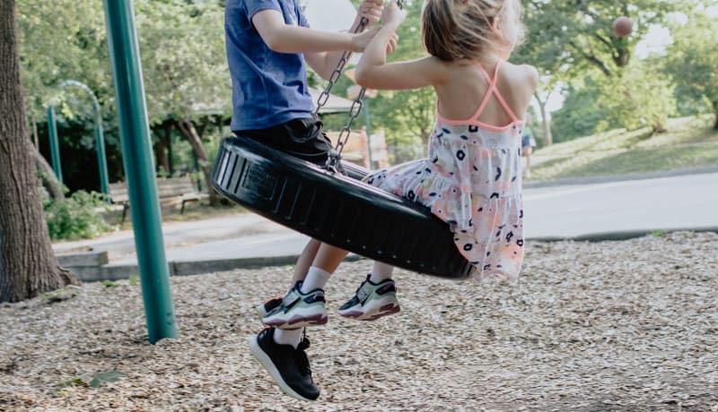 Photo of 2 children swinging on a tire by Kelly Sikkema on Unsplash