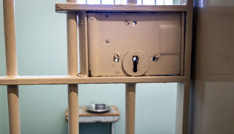 Photo of a lock on a prison cell door by Grant Durr on Unsplash