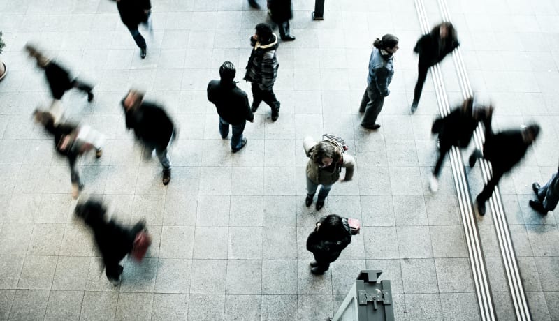 Photo of a crowd walking from above by Timon Studler on Unsplash