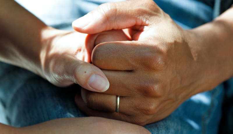 Photo of patients holding hands by National Cancer Institute on Unsplash
