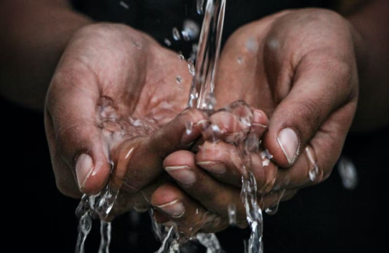 Photo of water pouring over hands by mrjn Photography on Unsplash