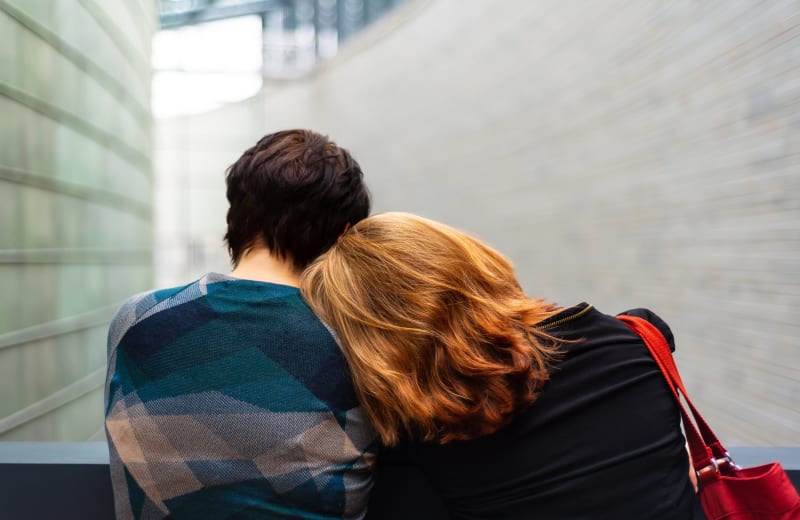Photo of one person with their head on another persons shoulder by Külli Kittus on Unsplash