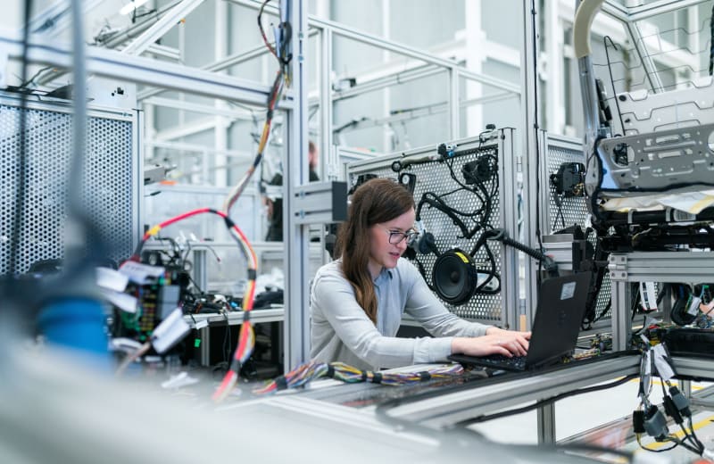 Photo of a female engineer running tests by ThisisEngineering RAEng on Unsplash