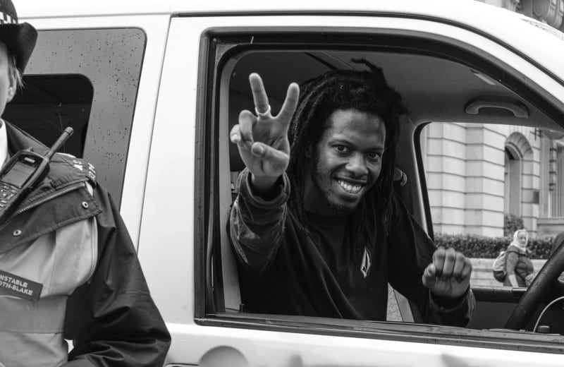 Photo of a man holding up his fingers in a peace sign by Ehimetalor Akhere Unuabona on Unsplash