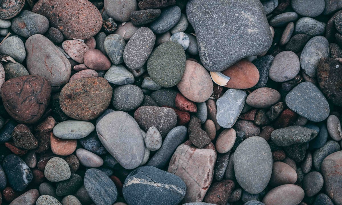 Photo of rocks on a beach by Oliver Paaske on Unsplash